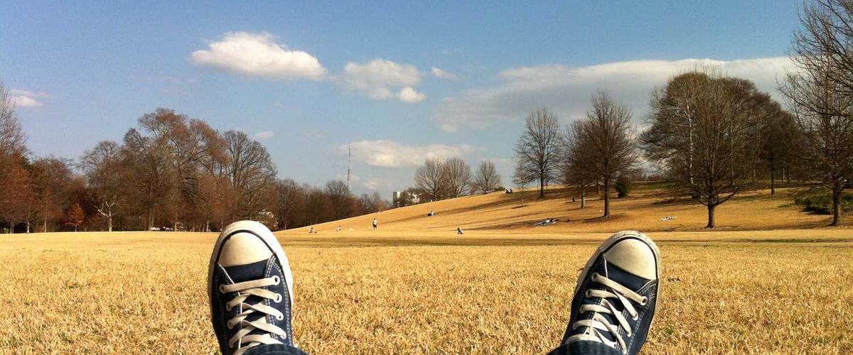Exterior of Phoenix stucco home being painted by professional team with proper ladders and equipment